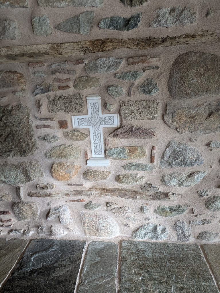 A cross set into an old stone wall