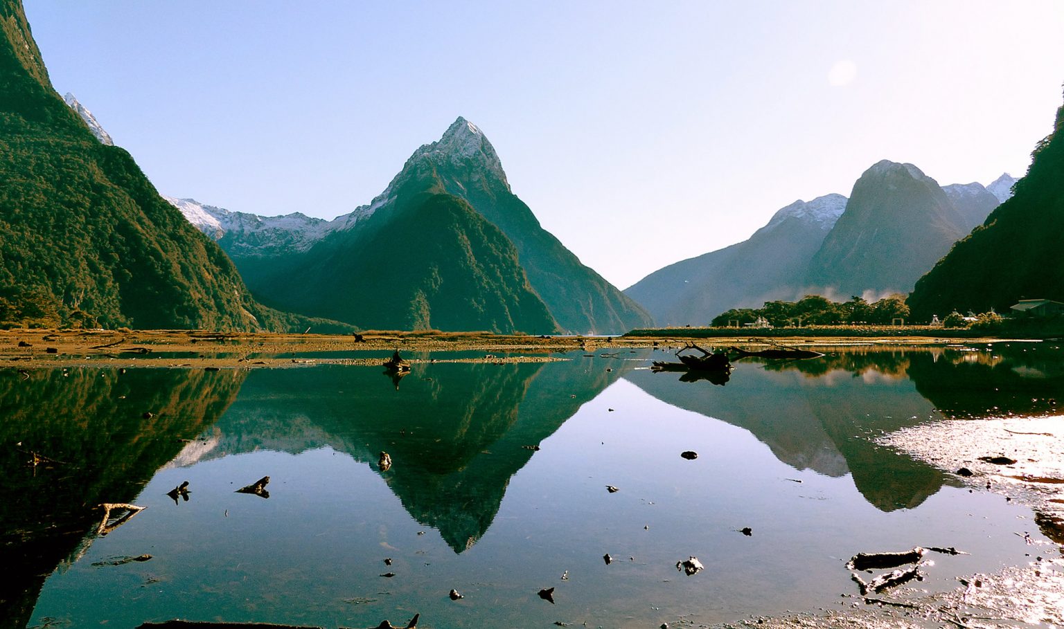 A calm mountain lake reflecting the peaks above it
