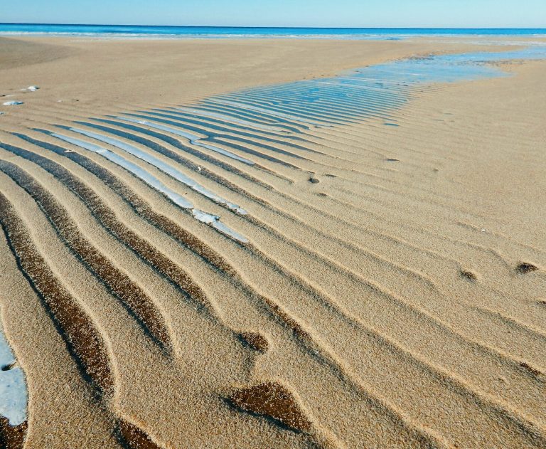 Soft ripples in the sand on a beach